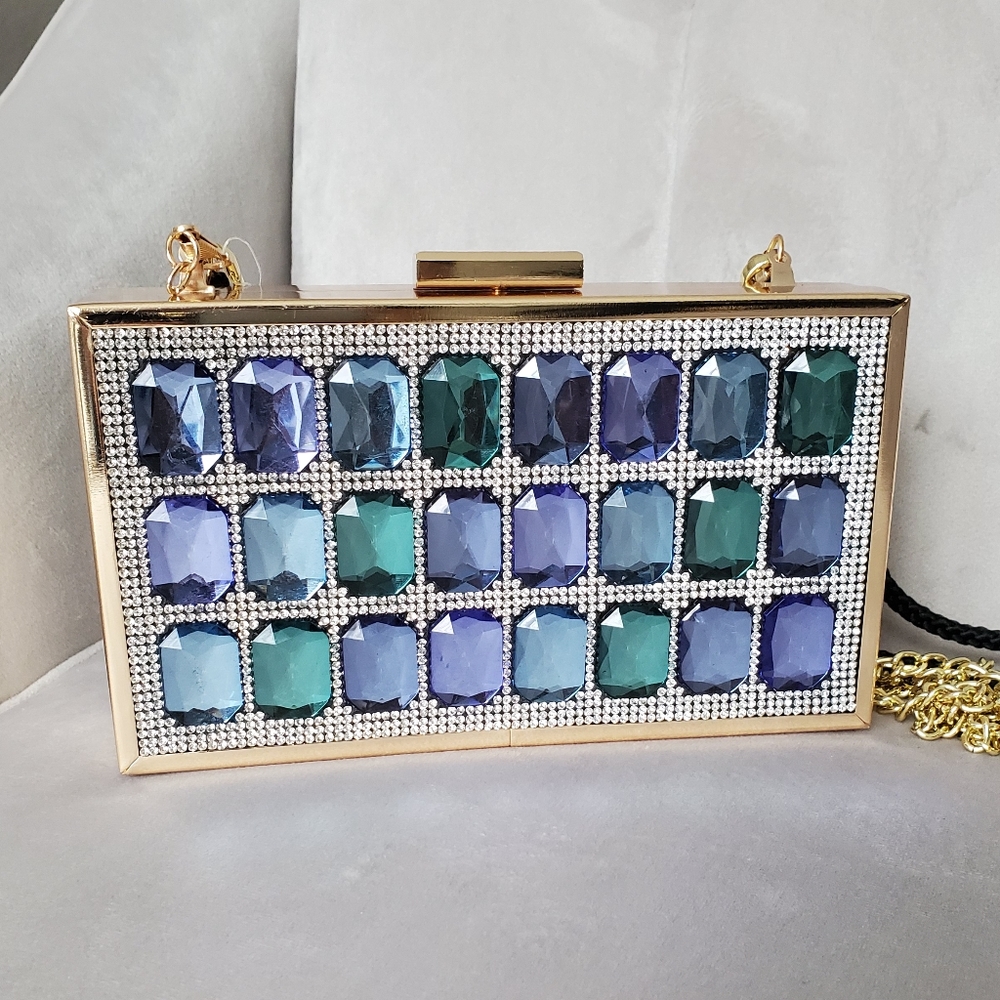 Gold box bag with blue and green rhinestones.